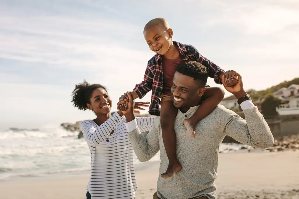 A family smiling on a beach