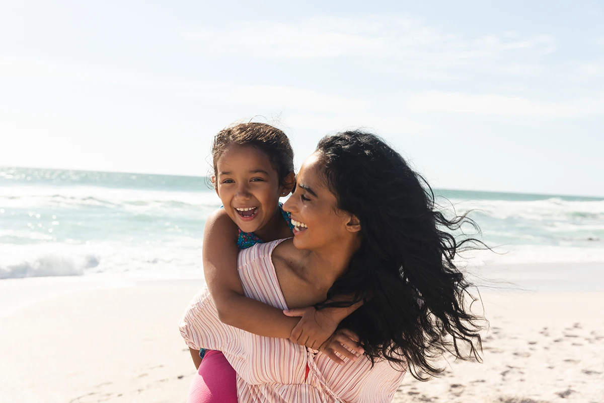 woman and daughter on beach