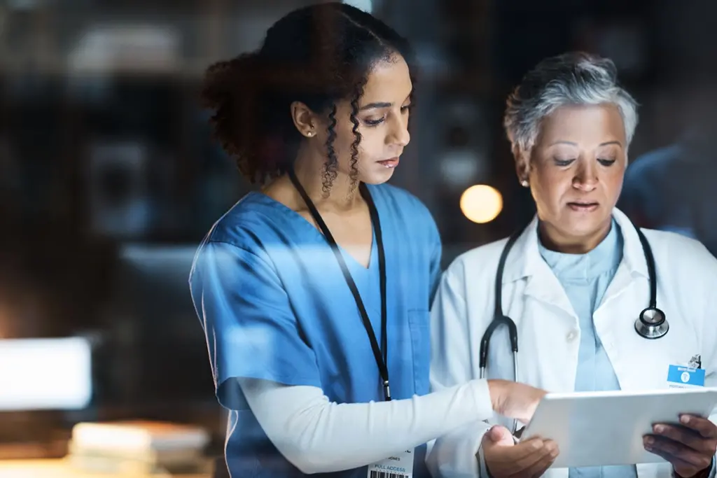 doctor and nurse looking at tablet