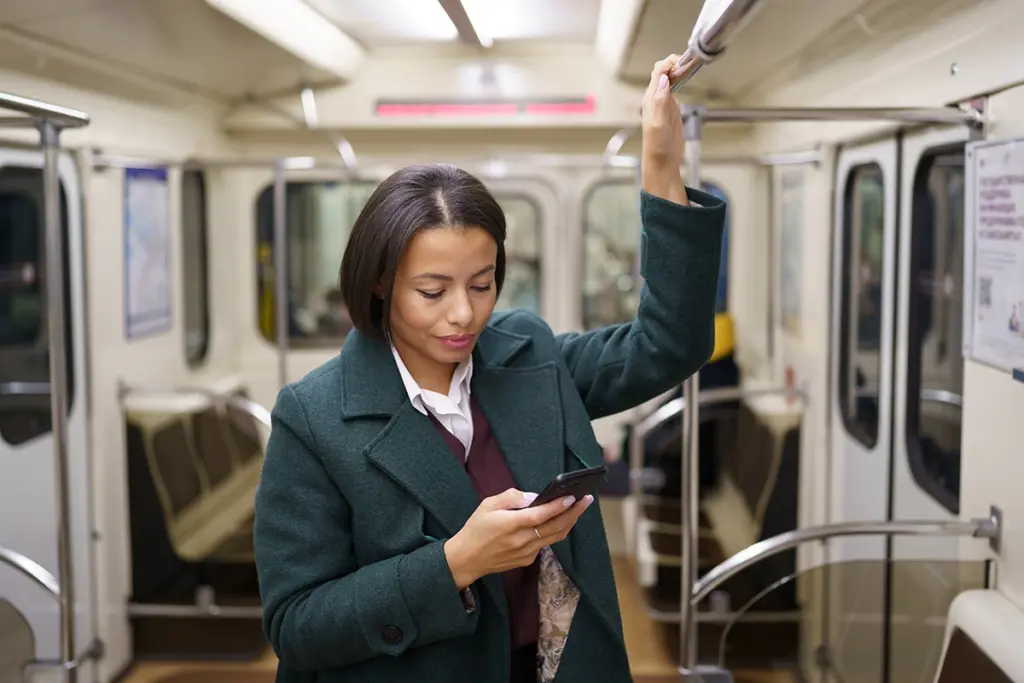 woman on subway looking at a phone