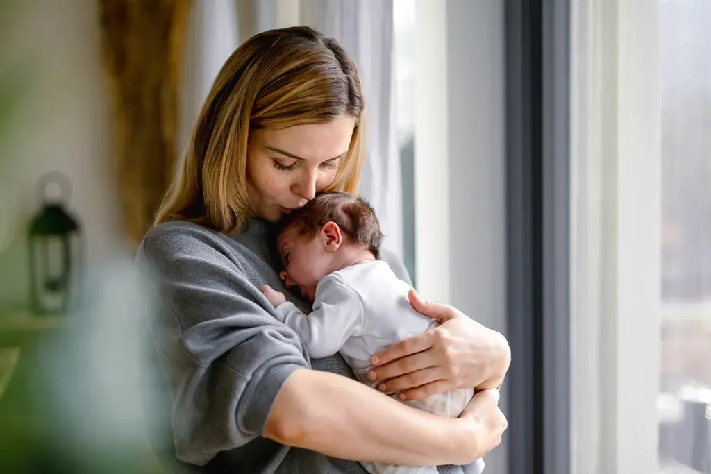 mother holding newborn