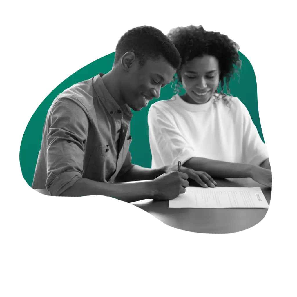 couple at desk signing paperwork